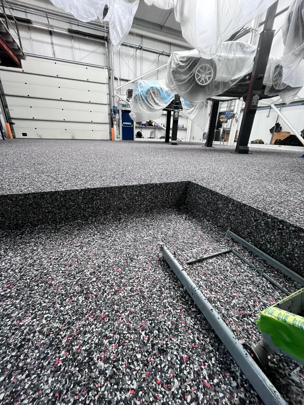 Automotive workshop epoxy flooring around an inspection pit