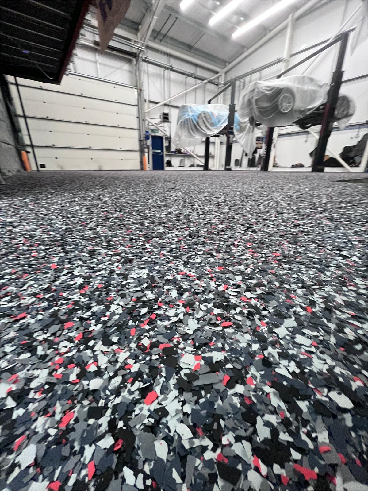 Industrial resin flake floor system in a vehicle storage facility